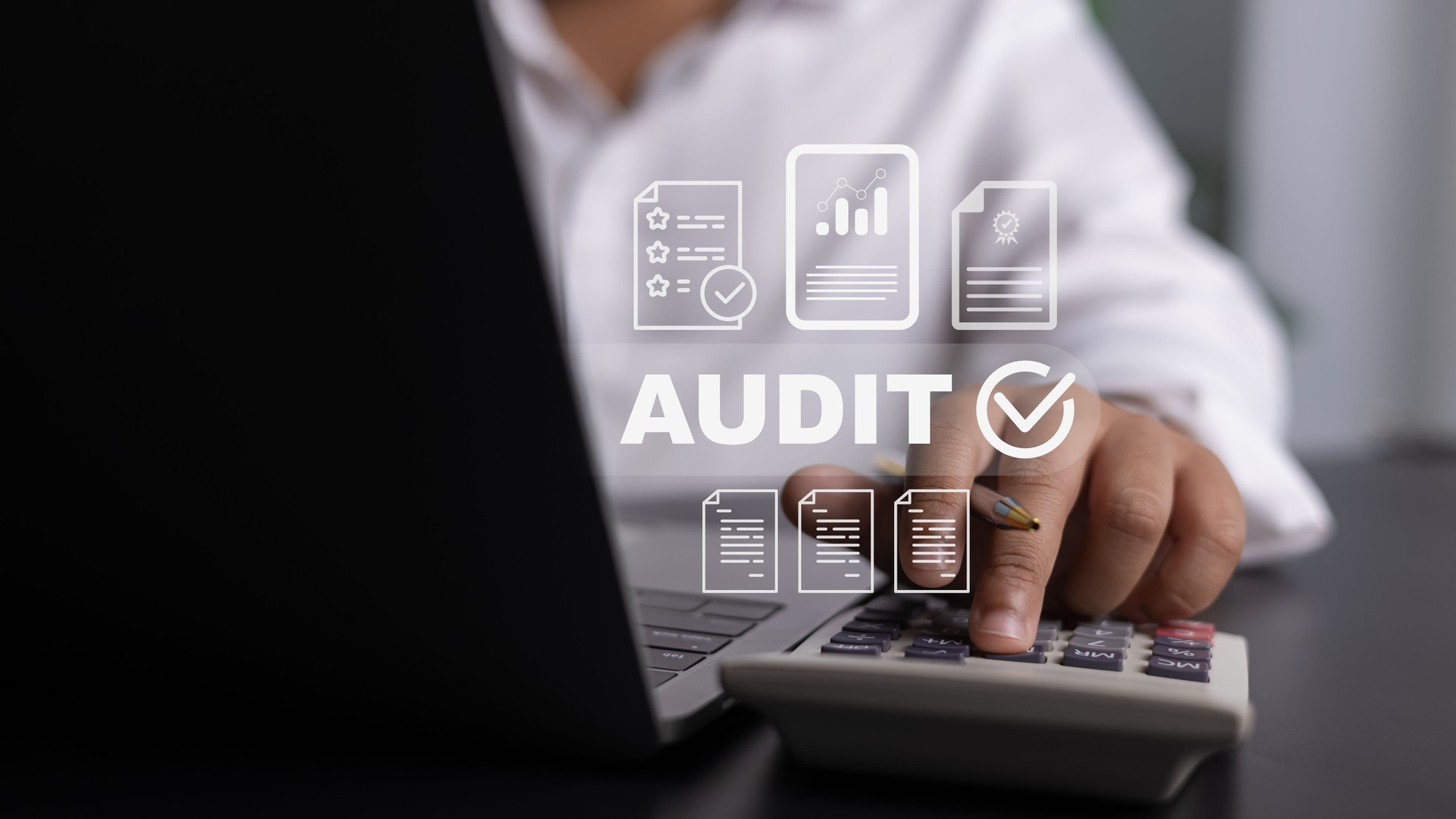 Close-up of calculator and laptop with AUDIT digital overlay for financial compliance Close-up of calculator and laptop with AUDIT digital overlay for financial compliance